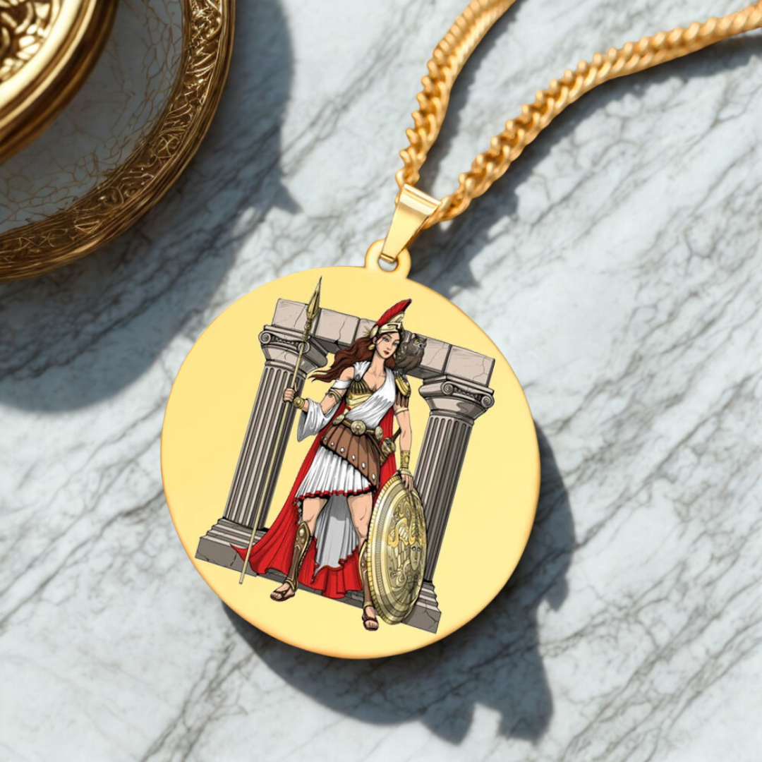 Gold pendant with a Goddess Athena design on a marble surface