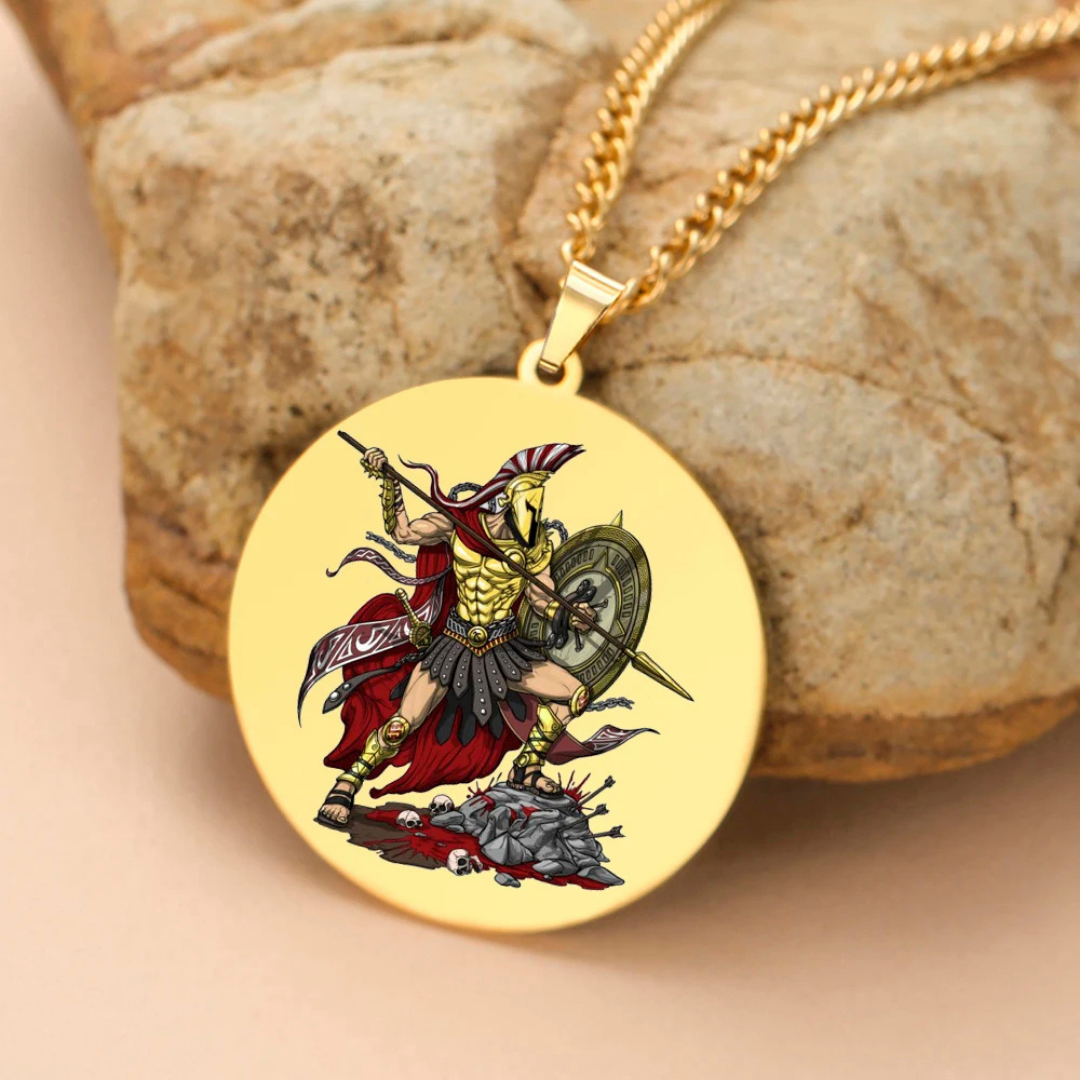 Gold pendant with the Greek God Ares as a warrior design on a stone surface
