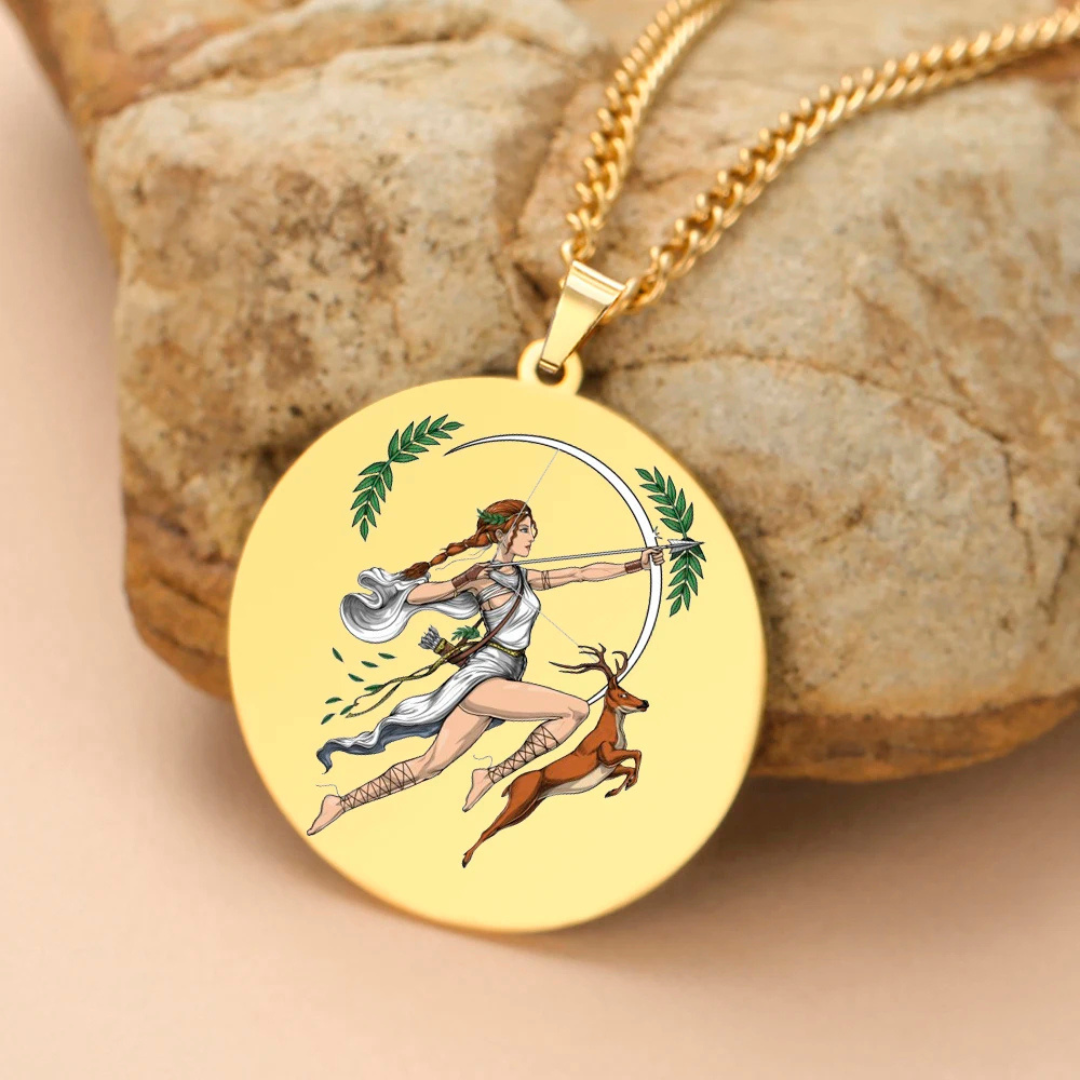 Gold necklace with a pendant featuring an illustration of Goddess Artemis, an archer, on a stone surface