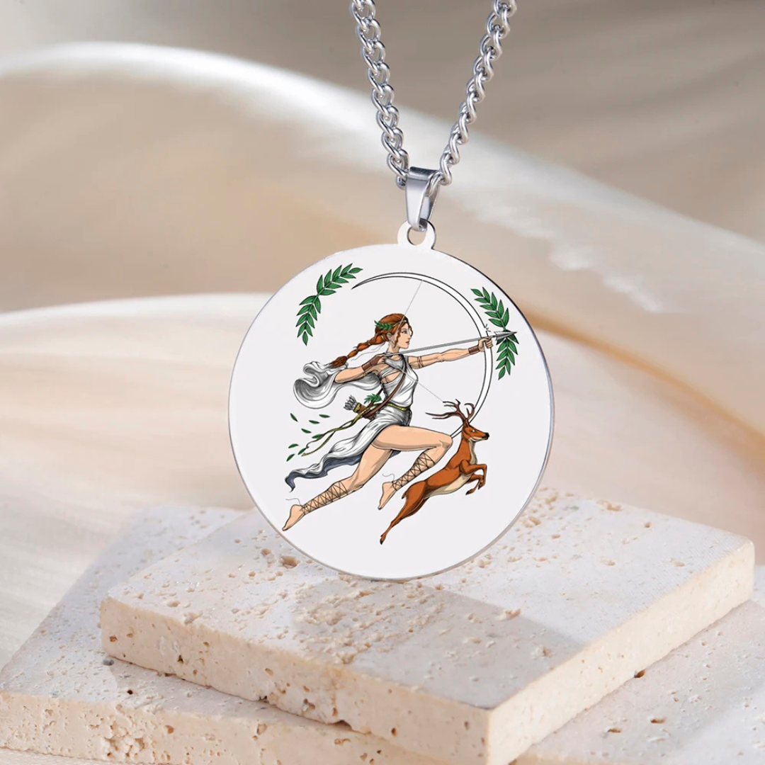 Necklace with a pendant featuring an illustration of  Goddess Artemis, a woman with a bow and a deer on a beige background.