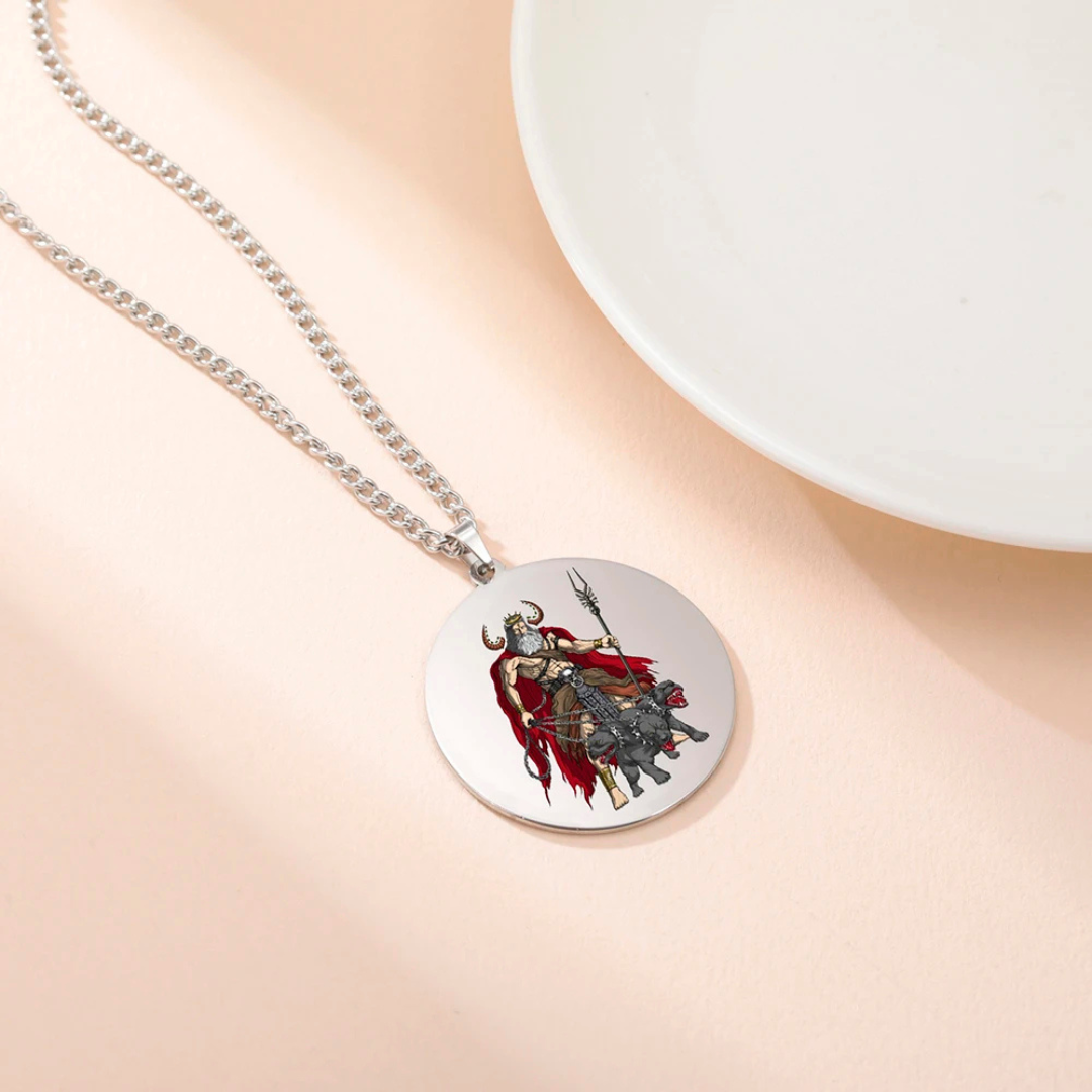 Necklace with a round pendant featuring an illustration of Hades & Cerberus on a beige surface.
