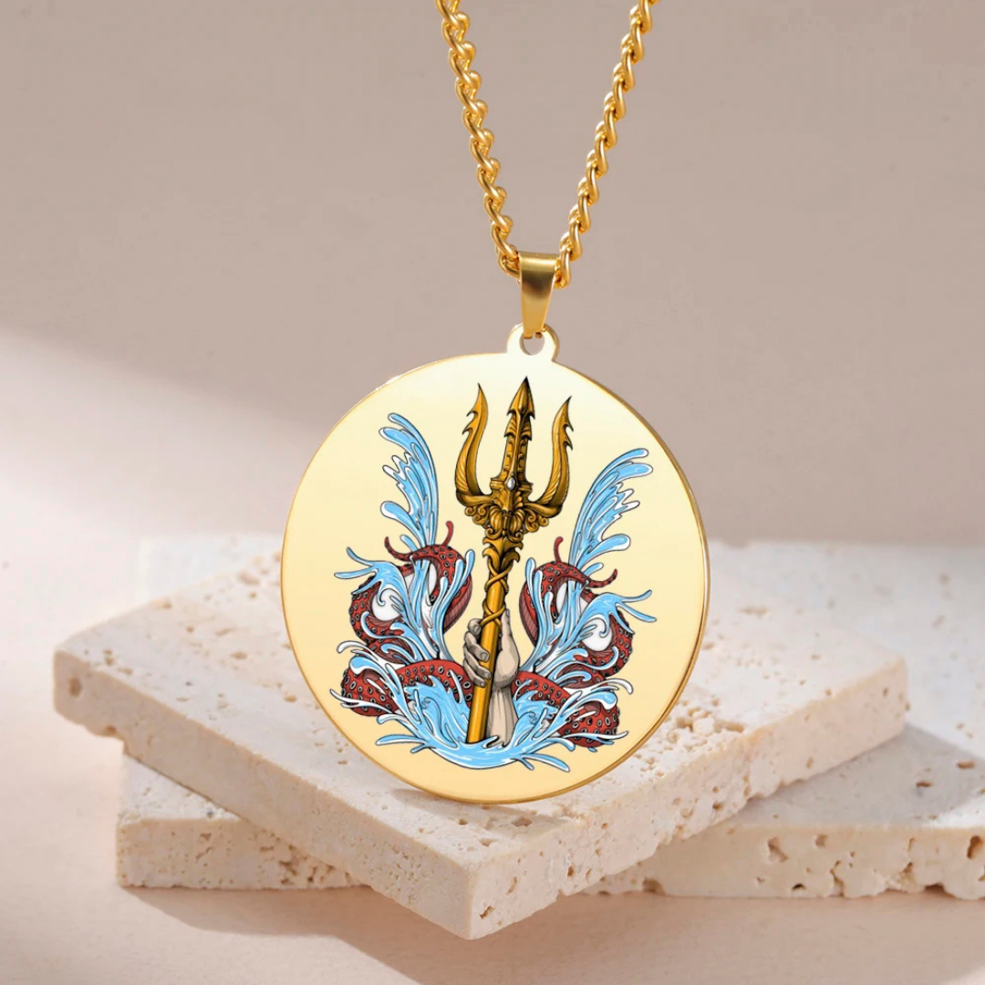 Gold necklace with a trident and wave design pendant on a beige background