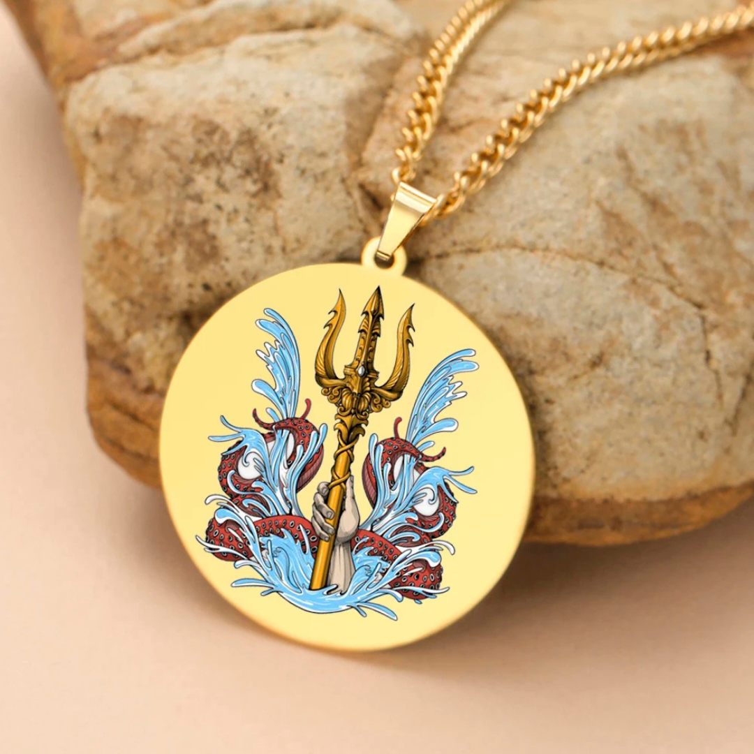 Gold necklace with a trident pendant on a stone background