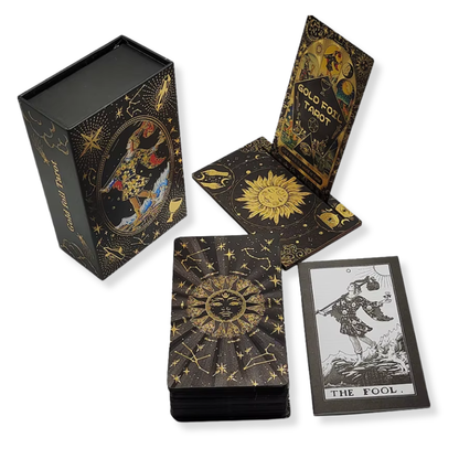 Black and gold tarot card set with decorative box on a white background