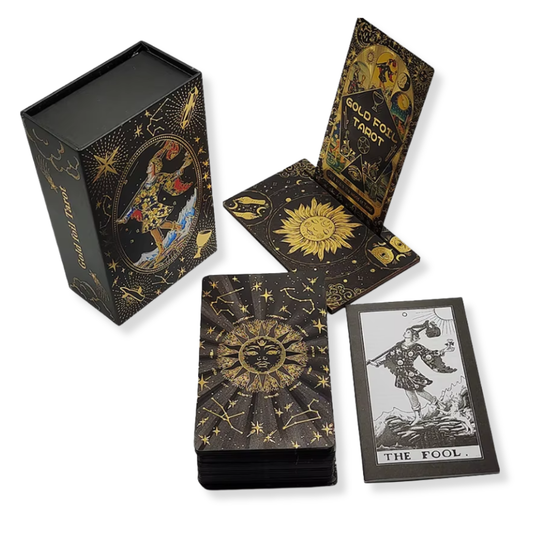 Black and gold tarot card set with decorative box on a white background