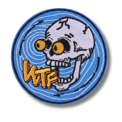 Circular patch with a skeleton wearing goggles and 'WTF' text on a blue background
