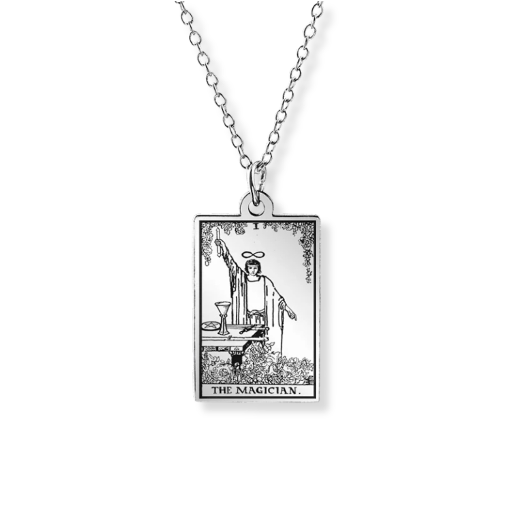 A silver-toned pendant necklace featuring the 'The Magician' tarot card design, suspended from a delicate link chain against a plain white background.
