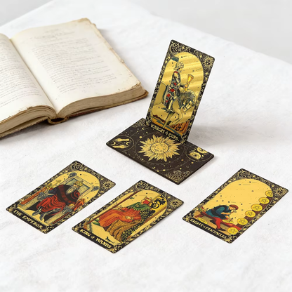 Set of tarot cards on a white surface with an open book.