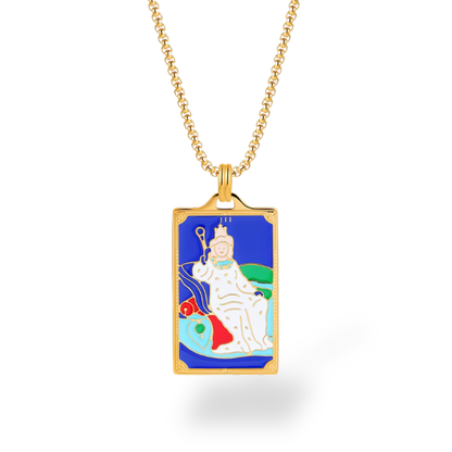 Gold necklace with a rectangular pendant featuring an illustration of a figure on a blue background.