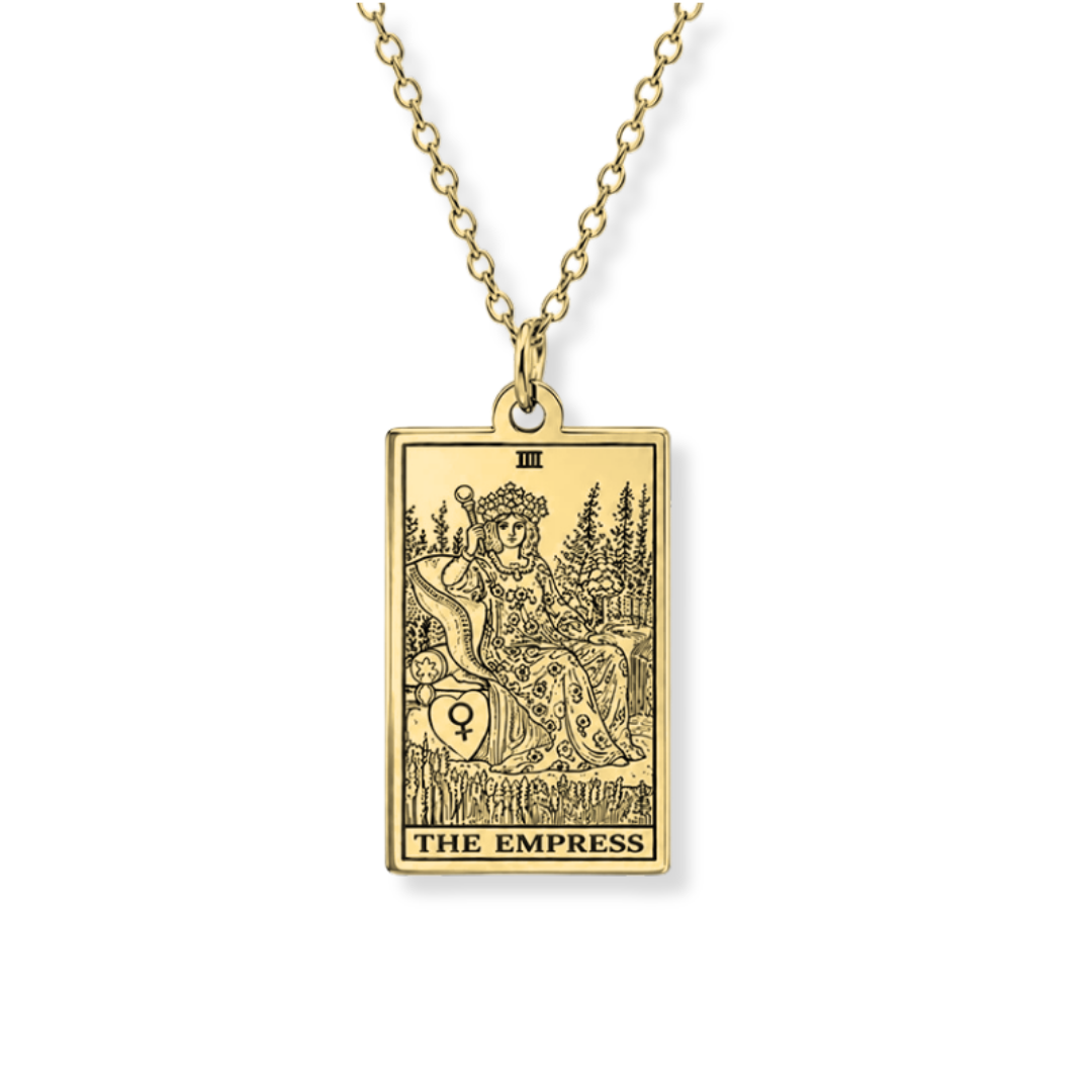 A gold-toned tarot card pendant necklace featuring 'The Empress' card, suspended from a matching chain against a plain white background.