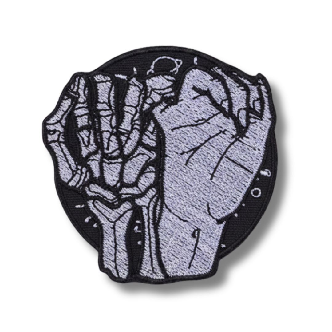 Patch with skeleton hand design on a white background
