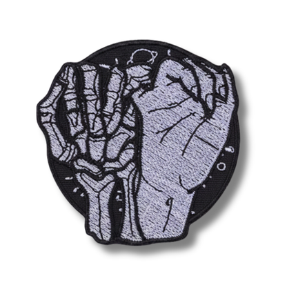 Patch with skeleton hand design on a white background