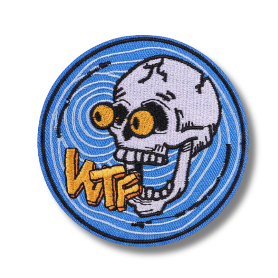 Circular patch with a skull design and 'WTF' text on a blue background