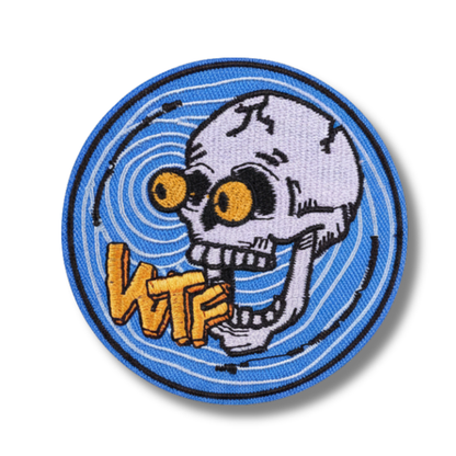 Circular patch with a skull design and 'WTF' text on a blue background
