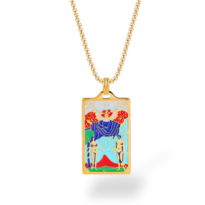 Gold necklace with a colorful pendant featuring two figures and flowers on a white background
