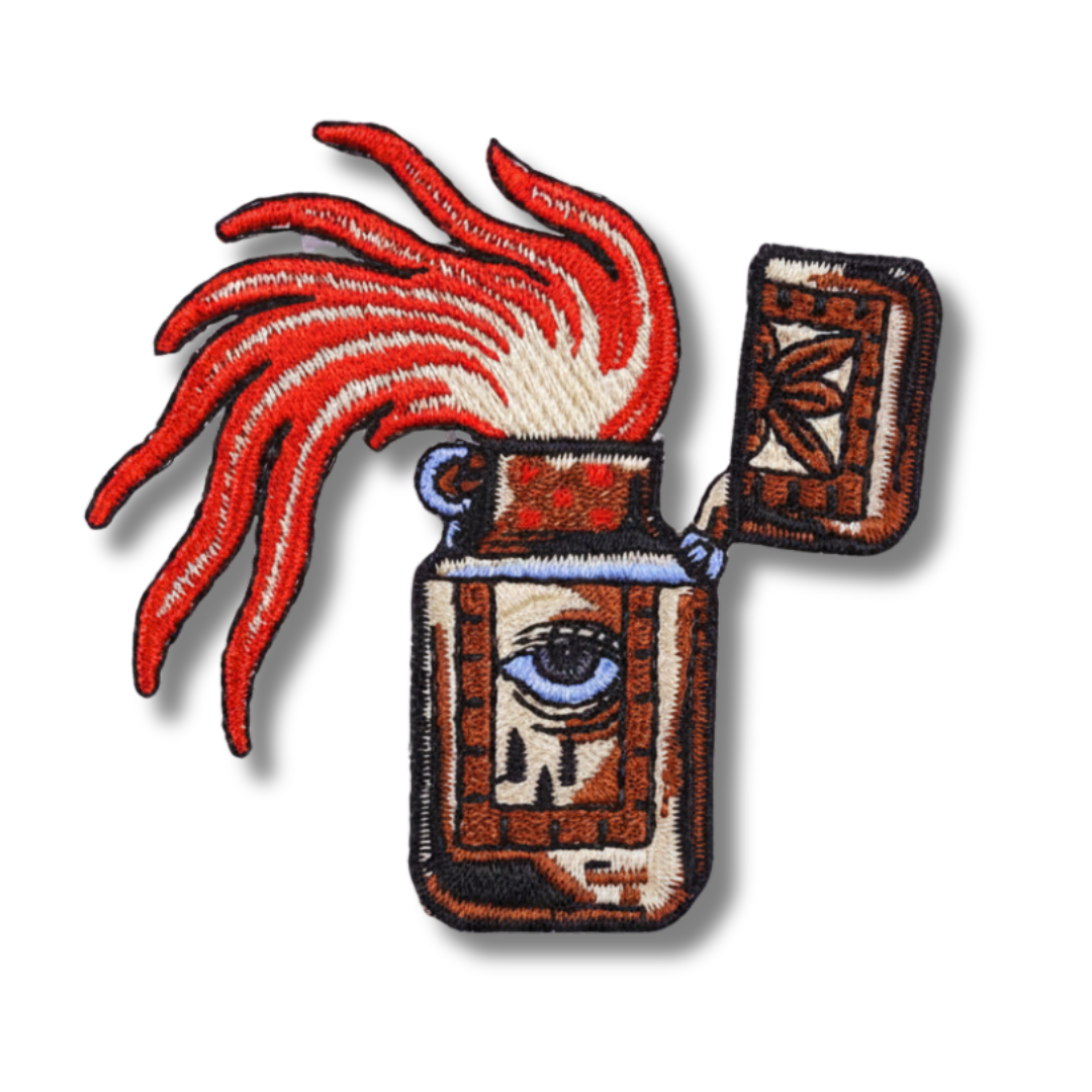 Embroidered patch of a lighter with red hair on a white background