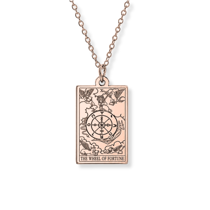 A rose gold rectangular pendant necklace featuring the 'The Wheel of Fortune' tarot card design, suspended from a matching rose gold chain against a plain white background.