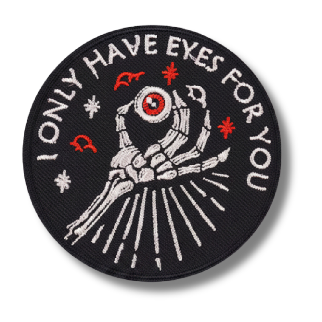 Embroidered patch with skeleton hand holding an eye and text 'ONLY HAVE EYES FOR YOU' on a black background.