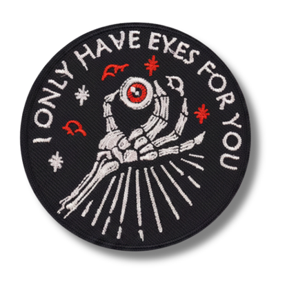 Embroidered patch with skeleton hand holding an eye and text 'ONLY HAVE EYES FOR YOU' on a black background.