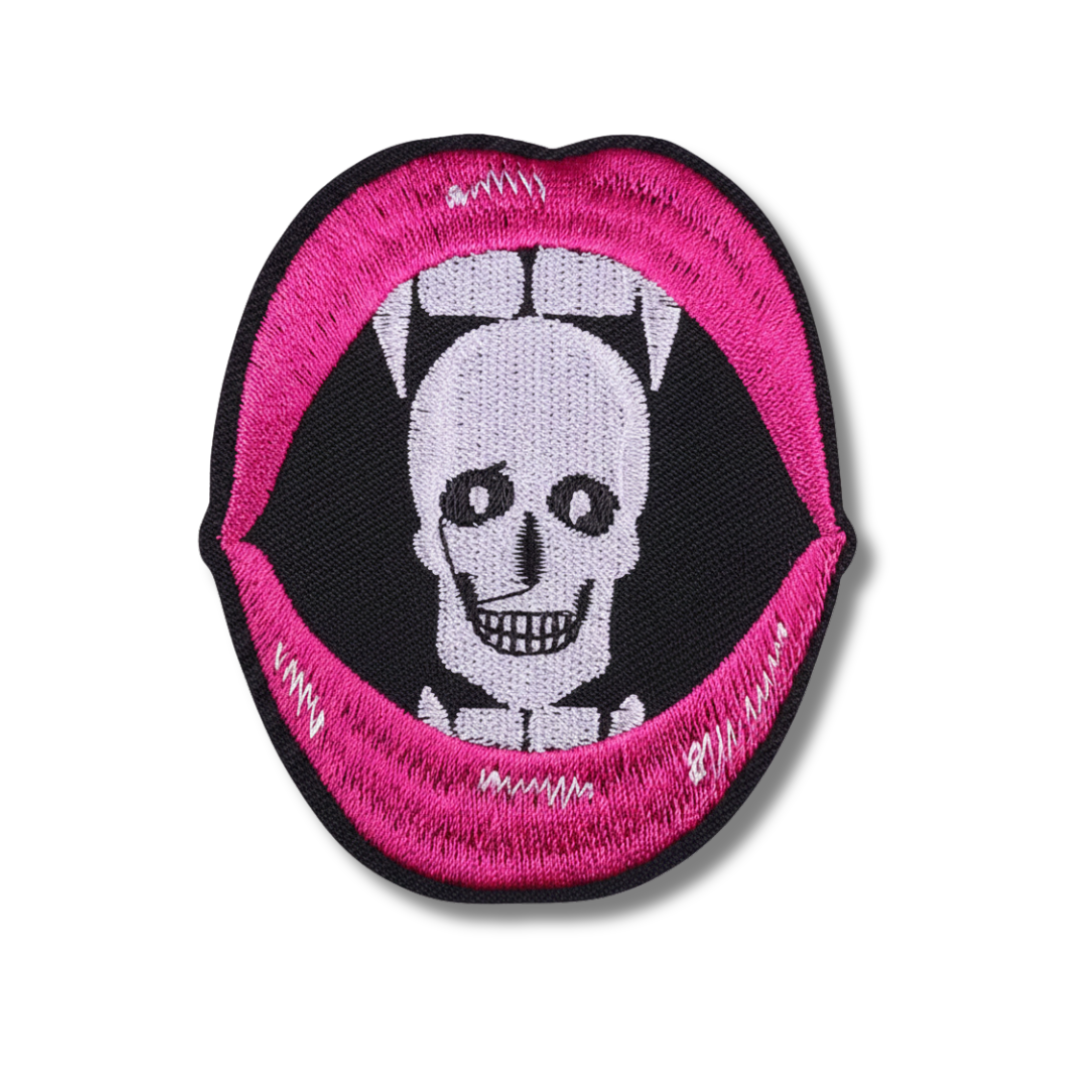 Patch with a skull design inside a pink and black border on a white background