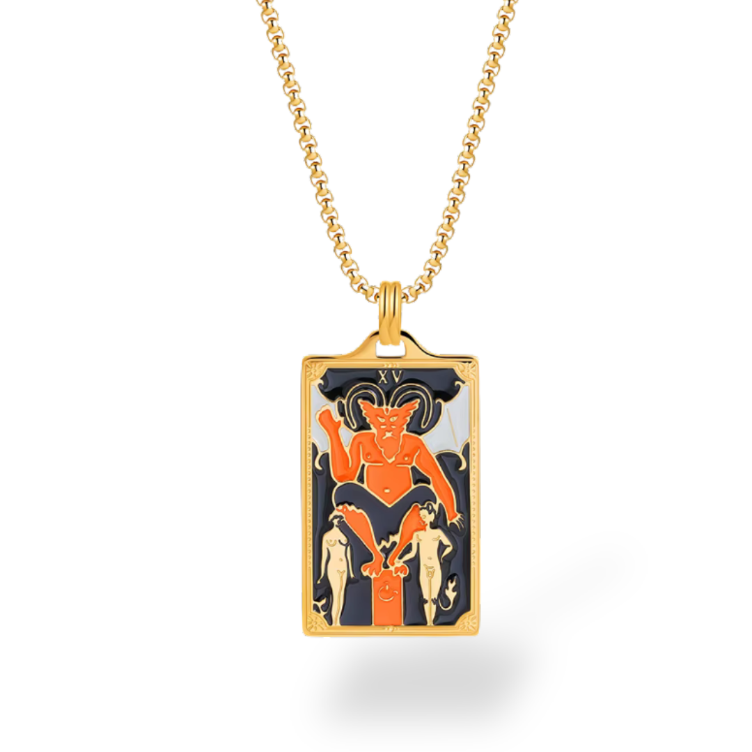 Gold necklace with a rectangular pendant featuring engravings on a white background