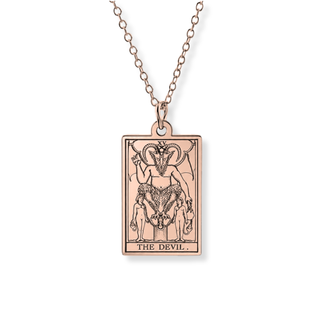 A rose gold tarot card pendant necklace featuring 'The Devil' card design, suspended from a matching rose gold chain against a plain white background.