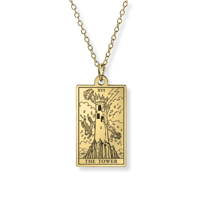A gold-toned tarot card pendant necklace featuring 'The Tower' (XVI) card design, suspended from a matching chain against a plain white background.