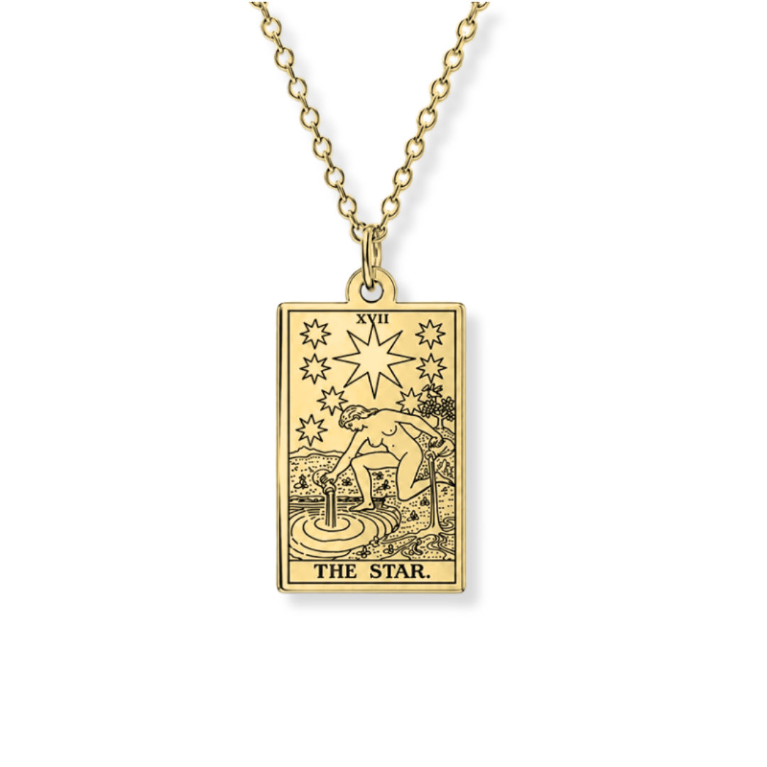 A gold-toned tarot card pendant necklace featuring 'The Star' (XVII) card design, suspended from a matching chain against a plain white background.