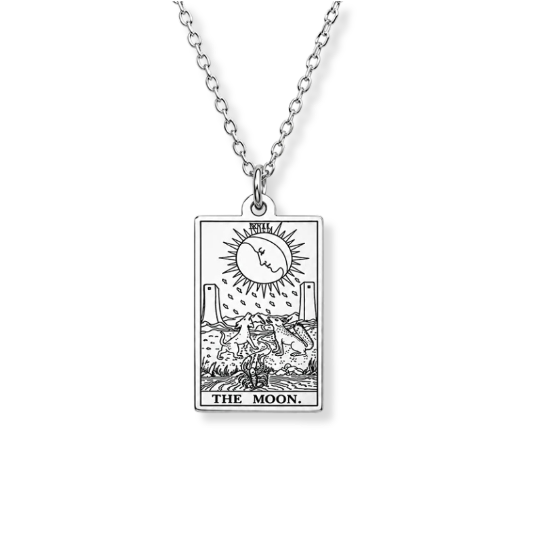 A silver-toned necklace with a rectangular pendant featuring the 'The Moon' tarot card design, shown against a plain white background.