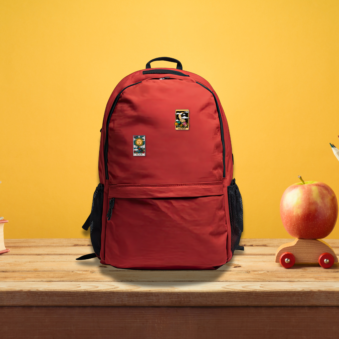 The Sun tarot card enamel pin styled on red backpack demonstrating how pin looks when worn on bags and backpacks for everyday use