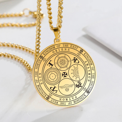 Gold necklace with a round pendant engraved with the Four Kings Seal against a white background