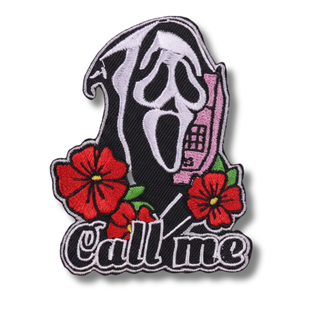 Embroidered patch with a ghost face design and flowers, featuring the text 'Call me'.