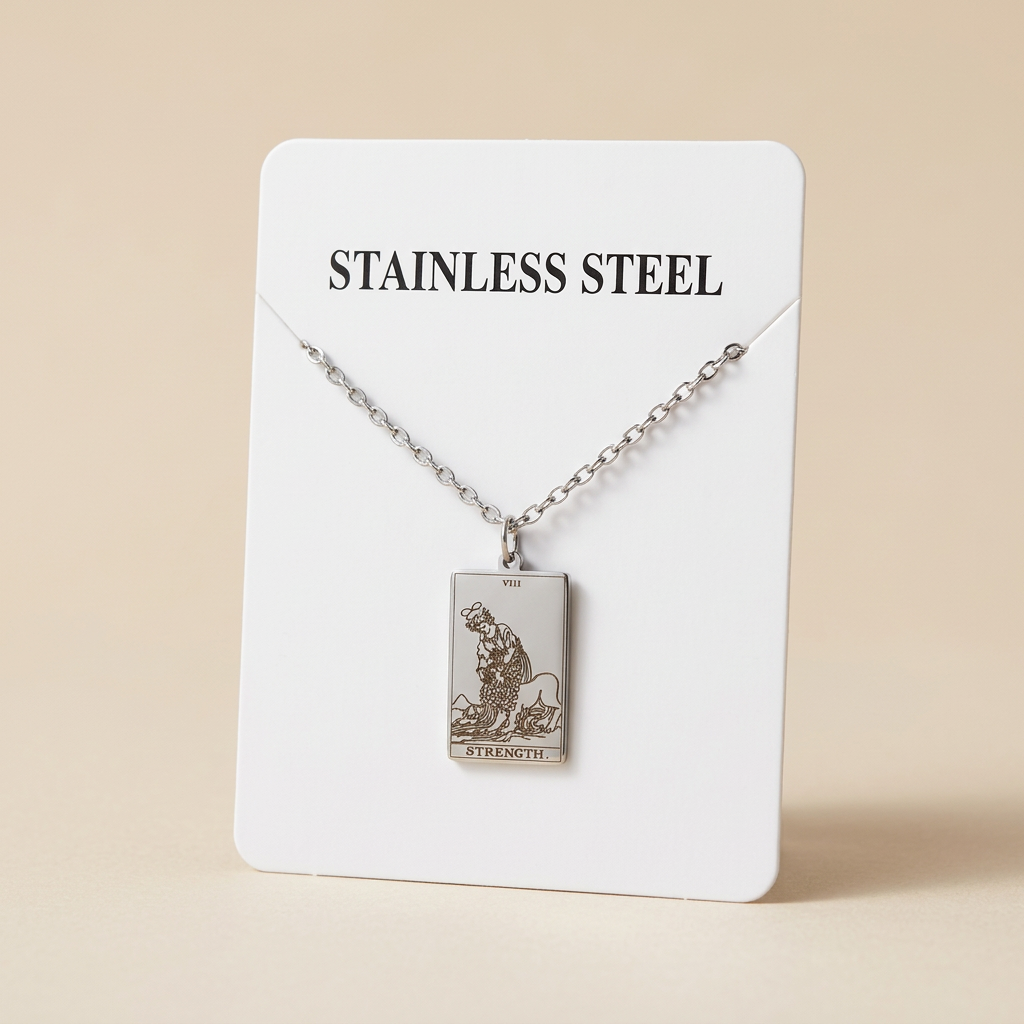 A stainless steel tarot card pendant necklace on a matching chain, displayed on a white backing card labeled 'STAINLESS STEEL'.