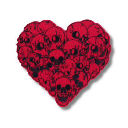 Heart-shaped patch with black skull design on a red background
