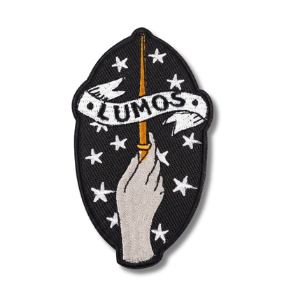 Embroidered patch with 'LUMOS' text, hand holding a wand, and stars on a black background