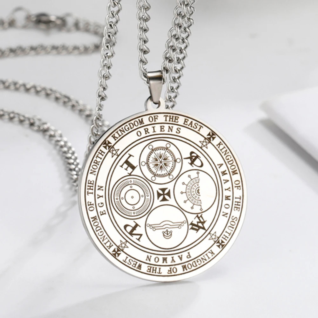 Circular pendant engraved with the Four Kings Seal on a silver chain against a light background