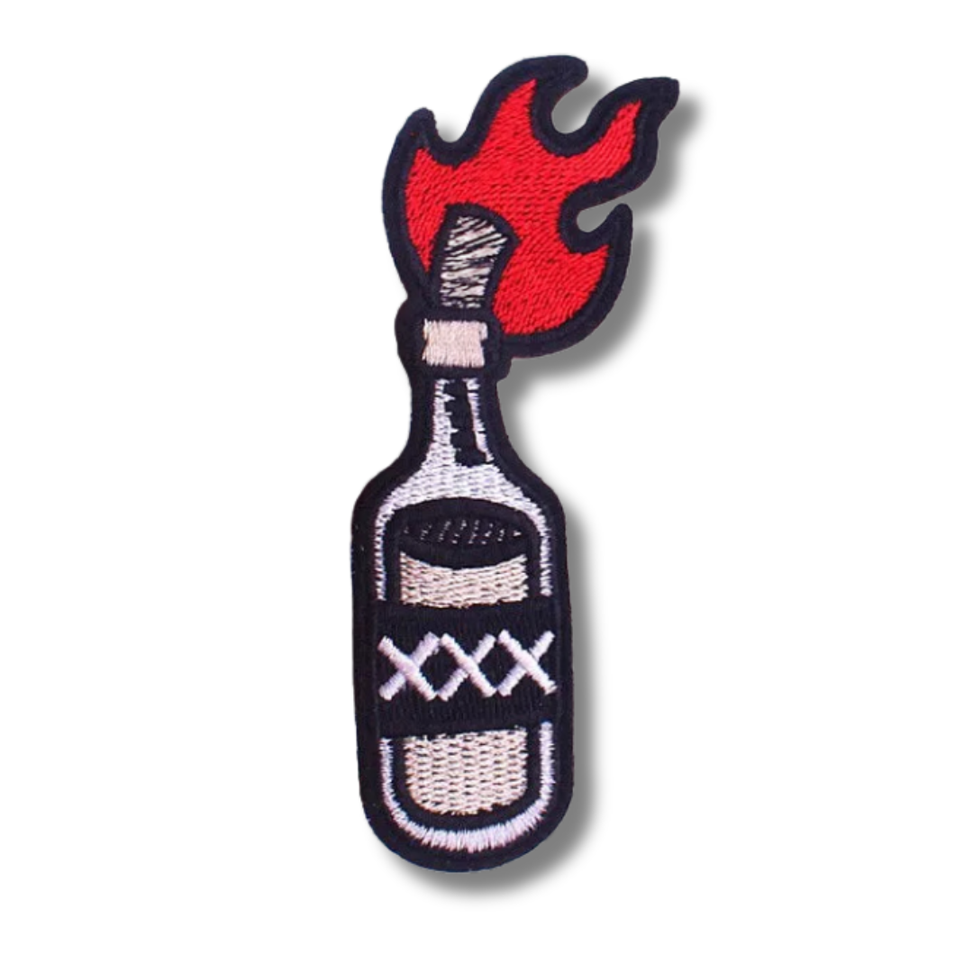 Embroidered patch of a bottle with flames on a white background