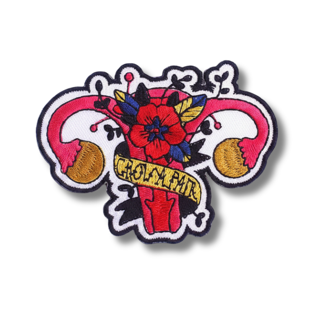 Colorful embroidered patch with floral design and text on a white background