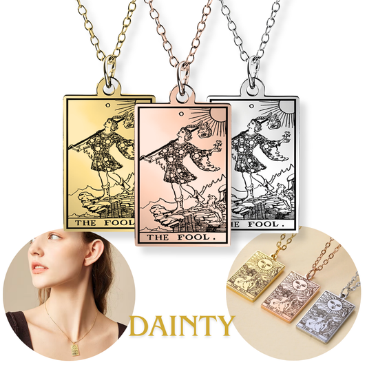 Three rectangular pendant necklaces with tarot card 'The Fool' illustrations in gold, rose gold, and silver finishes, shown with chains and a small circular inset of a woman wearing a gold version. The word 'DAINTY' appears at the bottom.