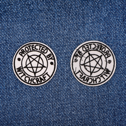 Two 'Protected by Witchcraft' patches on a denim background